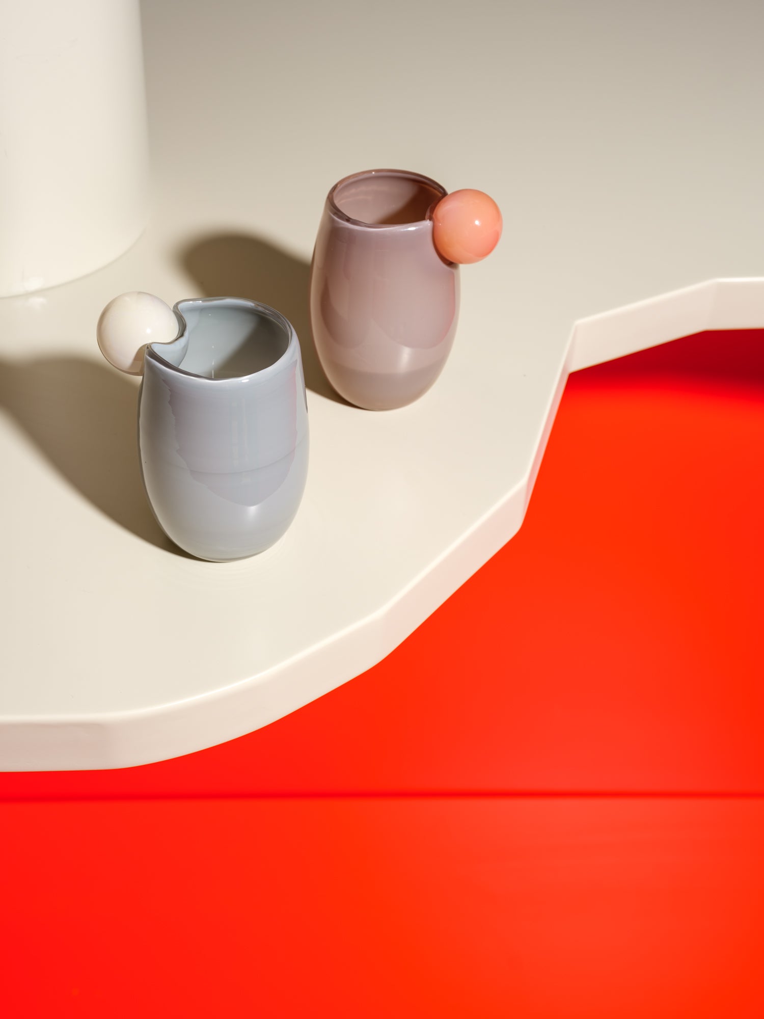 Cup made of glass with a ball on the side in light pink and purple